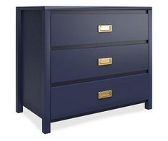 a blue chest of drawers with gold handles and knobs on the bottom, against a white background