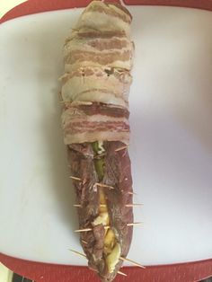 a large piece of meat is wrapped in toothpicks