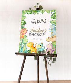 a welcome sign for a baby's shower is displayed on an easel in front of a white wall