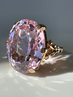 Pretty in Pink! This magnificent Kunzite, weighing a massive 39.9 carats, is perfectly presented in a simple prong setting made of 14k gold with scroll details.  Estimated Gemstone weight 39.9 carats Gemstone dimensions 24.5 x 19.25 x 13.3mm 14k gold Weight 18.2 grams Currently Size 9.25 and easily sizeable Note: the color of Kunzite can fade if exposed to strong sunlight for long periods of time. Mafia Princess, Hand Brooch, Kunzite Ring, Pink Gemstones Ring, Pink Kunzite, Princess Luna, Gold Cocktail Ring, Etsy Gold Ring, Spring Jewelry