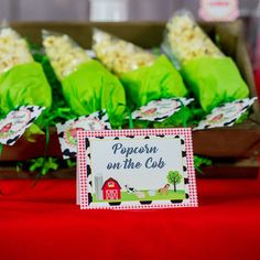 popcorn on the cob at a farm themed birthday party with red and green napkins