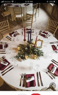 the table is set with red napkins and place settings