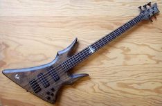 an electric bass guitar sitting on top of a wooden table