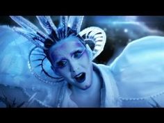 a woman with blue makeup and wings on her face