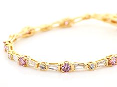 Bella Luce ® pink and white diamond simulants 10.50ctw round and tapered baguette, Eterno™ 18k yellow gold over sterling silver tennis bracelet. Measures approximately 7.25" or 8"L x 0.13"W and has a hidden box closure. The diamond equivalent weight is 7.04ctw. Elegant Pink Jewelry With Channel Set, Pink Jewelry With Baguette Diamonds For Anniversary, Elegant Pink Channel Set Jewelry, Silver Tennis Bracelet, Diamond Simulant, Tennis Bracelet, White Diamond, Pink And White, Cubic Zirconia