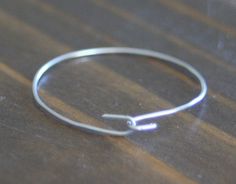 a silver ring sitting on top of a wooden table