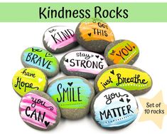 some rocks with words painted on them