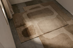 two rugs on the floor in a bathroom