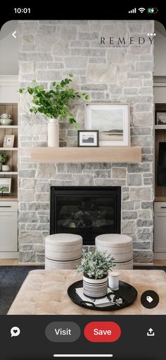 a living room filled with furniture and a fire place in front of a stone fireplace