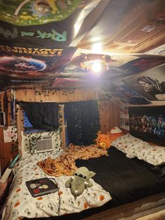 a room with a bed and many pictures on the walls, including an overhead fan