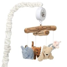 three stuffed animals hanging from a wooden mobile