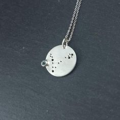 925 silver Constellation Medallion Medallion's dimensions The medallion is 16mm large circle. The gemstone is 3mm in diameter. Constellation medallion inspiration The best thing with this pendant is that it can be customized in so many ways! First, you can choose your favorite constellation among the selection (either zodiac constellations or other principal constellations, such as the Bid dipper or Cassiopeia). Then you can choose your favorite gemstone from the selection (garnet, amethyst, cub The Big Dipper, Graduation Rings, Big Dipper, Bridemaids Gifts, Constellation Necklace, Zodiac Necklace, Zodiac Constellations, Personalized Pendant, Celestial Jewelry