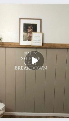 a white toilet sitting in a bathroom next to a wooden shelf with pictures on it