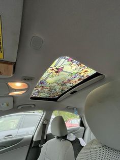 the interior of a car with a stained glass skylight in the back seat and sunroof