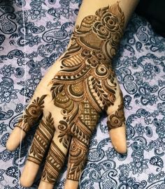 the hand is decorated with henna designs