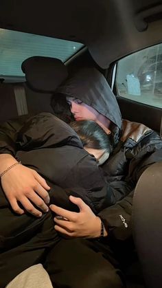 a woman sleeping in the back seat of a car