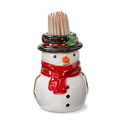 a white ceramic snowman with a red scarf and hat on it's head