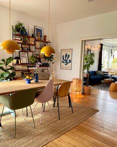 a dining room table with chairs and plants