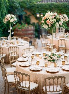 a table set up with white and pink flowers