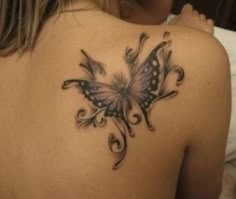 a woman with a butterfly tattoo on her back