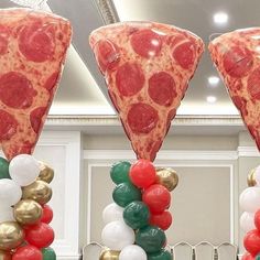 some pizza balloons are hanging from the ceiling