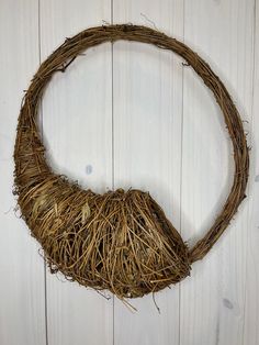 a bird nest hanging on the side of a wooden wall