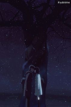 two people standing in front of a tree at night with the sky filled with stars