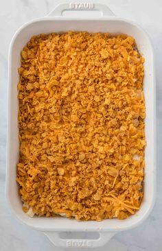 a casserole dish with shredded cheese in it