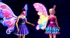 two girls dressed in colorful dresses standing next to each other with butterfly wings on their shoulders