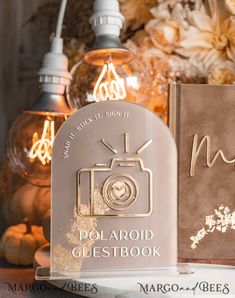 two books sitting next to each other on top of a table with flowers in the background