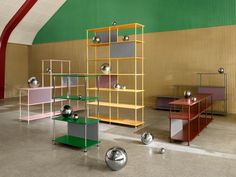 an empty room with several shelves and balls on the floor