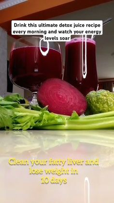 a table topped with glasses of juice and vegetables