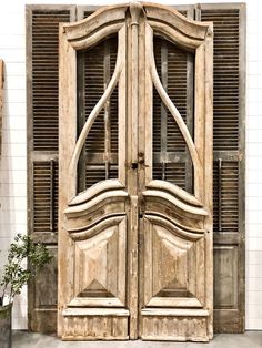 an old wooden double door with shutters