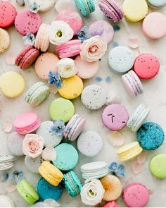 colorful macaroons and donuts on a white surface