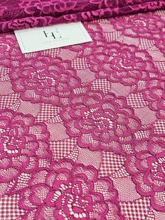 pink lace fabric with flowers on it