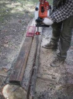 a man using a chainsaw to cut wood