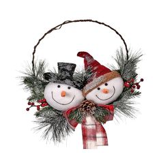 two snowmen are sitting in a basket with pine cones and evergreens on it