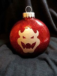 a red ornament with an evil face on it