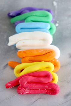 there are many different colored donuts on the table