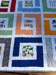 a colorful quilt with animals on it