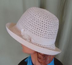 "This is a lovely vintage hat, that dates from the 90's. Label reads, \" San Diego Hat Co\". Made of polyester & paper straw. Tagged a size Women's O/S. It is an ivory mesh fedora with a white grosgrain ribbon hatband with chain accent. Brim can be worn up or down. Measures 22.5\" around the inside. The hat is in good, vintage condition. Shows no damage or wear. Chic!" Vintage White Fedora With Short Brim, Vintage White Fedora Hat, Vintage White Cloche Hat, Vintage White Panama Hat With Curved Brim, Vintage White Panama Fedora Hat, Vintage White Cloche Hat With Short Brim, Vintage White Mini Hat With Short Brim, White Classic Cloche Hat For Summer, Classic White Cloche Hat For Summer