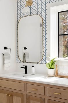 a bathroom with two sinks and a large mirror on the wall next to a window