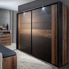 a bedroom with a bed, dresser and mirror on the wall next to each other