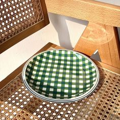 a green and white checkered plate sitting on top of a doily covered table