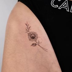 a woman's arm with a flower tattoo on the left side of her body