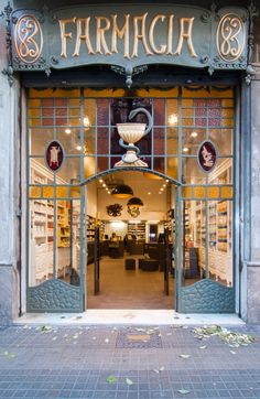 the front entrance to a store with an iron door and glass windows that says farmaca