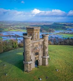 an aerial view of a castle with water in the background