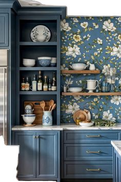 a kitchen with blue cabinets and floral wallpaper on the walls, along with wooden utensils