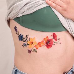 a woman's stomach with colorful flowers on it