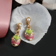 Let nothing stop you from indulging in these charming messengers of Springtime, renewal and love. Miniature eggs, hand enameled in pink and green, are decorated with a band of tiny aurora crystal. Post set with cultura pearl. Richly plated in 14K gold. Made in our Los Angeles studio. Shop the necklace here: https://www.etsy.com/listing/678973320 Shop the bracelet here: https://www.etsy.com/listing/693632609 Shop the set of necklace, earrings and bracelet here https://www.etsy.com/listing/6938398 Easter Egg Earrings, Egg Jewelry, Egg Earrings, Easter Jewelry, Easter Earrings, Jewelry Delicate, Egg Easter, Swarovski Beads, Easter Girl